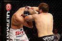 LAS VEGAS, NV - DECEMBER 29:  (R-L) Jim Miller punches Joe Lauzon during their lightweight fight at UFC 155 on December 29, 2012 at MGM Grand Garden Arena in Las Vegas, Nevada. (Photo by Josh Hedges/Zuffa LLC/Zuffa LLC via Getty Images) *** Local Caption *** Joe Lauzon; Jim Miller