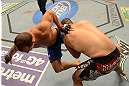 LAS VEGAS, NV - DECEMBER 29:  (R-L) Cain Velasquez takes down Junior dos Santos during their heavyweight championship fight at UFC 155 on December 29, 2012 at MGM Grand Garden Arena in Las Vegas, Nevada. (Photo by Donald Miralle/Zuffa LLC/Zuffa LLC via Getty Images) *** Local Caption *** Junior dos Santos; Cain Velasquez