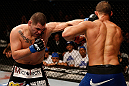 LAS VEGAS, NV - DECEMBER 29:  (L-R) Cain Velasquez punches Junior dos Santos during their heavyweight championship fight at UFC 155 on December 29, 2012 at MGM Grand Garden Arena in Las Vegas, Nevada. (Photo by Josh Hedges/Zuffa LLC/Zuffa LLC via Getty Images) *** Local Caption *** Junior dos Santos; Cain Velasquez