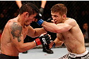 SAO PAULO, BRAZIL - JANUARY 19:  Nik Lentz (white shorts) punches Diego Nunes in their featherweight fight at the UFC on FX event on January 19, 2013 at Ibirapuera Gymnasium in Sao Paulo, Brazil. (Photo by Josh Hedges/Zuffa LLC/Zuffa LLC via Getty Images)