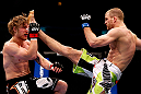 CHICAGO, IL - JANUARY 26:  Pascal Krauss (R) kicks Mike Stumpf (L) during their Welterweight Bout part of UFC on FOX at United Center on January 26, 2013 in Chicago, Illinois.  (Photo by Josh Hedges/Zuffa LLC/Zuffa LLC Via Getty Images)
