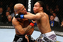 CHICAGO, IL - JANUARY 26:  John Dodson (R) punches Demetrious Johnson (L) during thier Flyweight Championship Bout part of UFC on FOX at United Center on January 26, 2013 in Chicago, Illinois.  (Photo by Al Bello/Zuffa LLC/Zuffa LLC Via Getty Images)
