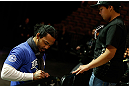 LAS VEGAS, NV - FEBRUARY 01:  UFC lightweight champion Benson Henderson signs an autograph for a young fan during a Q&A session before the UFC 156 weigh-in on February 1, 2013 at Mandalay Bay Events Center in Las Vegas, Nevada.  (Photo by Josh Hedges/Zuffa LLC/Zuffa LLC via Getty Images)