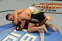 LAS VEGAS, NV - FEBRUARY 02:  Dustin Kimura (top) attempts to submit Chico Camus during their bantamweight fight at UFC 156 on February 2, 2013 at the Mandalay Bay Events Center in Las Vegas, Nevada.  (Photo by Donald Miralle/Zuffa LLC/Zuffa LLC via Getty Images) *** Local Caption *** Chico Camus; Dustin Kimura