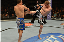 LAS VEGAS, NV - FEBRUARY 02:  (R-L) Evan Dunham kicks Gleison Tibau during their lightweight fight at UFC 156 on February 2, 2013 at the Mandalay Bay Events Center in Las Vegas, Nevada.  (Photo by Donald Miralle/Zuffa LLC/Zuffa LLC via Getty Images) *** Local Caption *** Gleison Tibau; Evan Dunham
