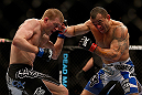 LAS VEGAS, NV - FEBRUARY 02:  (R-L) Gleison Tibau punches Evan Dunham during their lightweight fight at UFC 156 on February 2, 2013 at the Mandalay Bay Events Center in Las Vegas, Nevada.  (Photo by Josh Hedges/Zuffa LLC/Zuffa LLC via Getty Images) *** Local Caption *** Gleison Tibau; Evan Dunham
