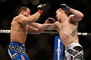 LAS VEGAS, NV - FEBRUARY 02:  (R-L) Evan Dunham punches Gleison Tibau during their lightweight fight at UFC 156 on February 2, 2013 at the Mandalay Bay Events Center in Las Vegas, Nevada.  (Photo by Josh Hedges/Zuffa LLC/Zuffa LLC via Getty Images) *** Local Caption *** Gleison Tibau; Evan Dunham