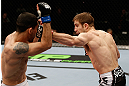 LONDON, ENGLAND - FEBRUARY 16:  (R-L) Phil Harris punches Ulysses Gomez in their flyweight fight during the UFC on Fuel TV event on February 16, 2013 at Wembley Arena in London, England.  (Photo by Josh Hedges/Zuffa LLC/Zuffa LLC via Getty Images)