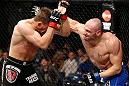 LONDON, ENGLAND - FEBRUARY 16:  (R-L) Stanislav Nedkov punches Tom Watson in their middleweight fight during the UFC on Fuel TV event on February 16, 2013 at Wembley Arena in London, England.  (Photo by Josh Hedges/Zuffa LLC/Zuffa LLC via Getty Images)