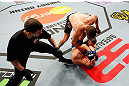LONDON, ENGLAND - FEBRUARY 16:   Tom Watson (top) punches Stanislav Nedkov in their middleweight fight during the UFC on Fuel TV event on February 16, 2013 at Wembley Arena in London, England.  (Photo by Josh Hedges/Zuffa LLC/Zuffa LLC via Getty Images)