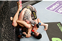 LONDON, ENGLAND - FEBRUARY 16:  (R-L) Josh Grispi attempts a triangle choke against Andy Ogle in their featherweight fight during the UFC on Fuel TV event on February 16, 2013 at Wembley Arena in London, England.  (Photo by Josh Hedges/Zuffa LLC/Zuffa LLC via Getty Images)