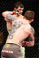 LONDON, ENGLAND - FEBRUARY 16:  (R-L) Andy Ogle punches Josh Grispi in their featherweight fight during the UFC on Fuel TV event on February 16, 2013 at Wembley Arena in London, England.  (Photo by Josh Hedges/Zuffa LLC/Zuffa LLC via Getty Images)