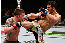 LONDON, ENGLAND - FEBRUARY 16:  (L-R) Andy Ogle and Josh Grispi trade strikes in their featherweight fight during the UFC on Fuel TV event on February 16, 2013 at Wembley Arena in London, England.  (Photo by Josh Hedges/Zuffa LLC/Zuffa LLC via Getty Images)
