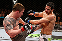 LONDON, ENGLAND - FEBRUARY 16:  (L-R) Andy Ogle kicks Josh Grispi in their featherweight fight during the UFC on Fuel TV event on February 16, 2013 at Wembley Arena in London, England.  (Photo by Josh Hedges/Zuffa LLC/Zuffa LLC via Getty Images)