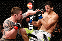 LONDON, ENGLAND - FEBRUARY 16:  (L-R) Andy Ogle punches Josh Grispi in their featherweight fight during the UFC on Fuel TV event on February 16, 2013 at Wembley Arena in London, England.  (Photo by Josh Hedges/Zuffa LLC/Zuffa LLC via Getty Images)