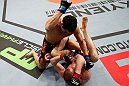 LONDON, ENGLAND - FEBRUARY 16:  (L-R) Danny Castillo punches Paul Sass in their lightweight fight during the UFC on Fuel TV event on February 16, 2013 at Wembley Arena in London, England.  (Photo by Josh Hedges/Zuffa LLC/Zuffa LLC via Getty Images)