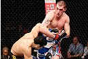 LONDON, ENGLAND - FEBRUARY 16:  (R-L) Paul Sass punches Danny Castillo in their lightweight fight during the UFC on Fuel TV event on February 16, 2013 at Wembley Arena in London, England.  (Photo by Josh Hedges/Zuffa LLC/Zuffa LLC via Getty Images)
