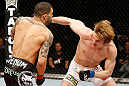 LONDON, ENGLAND - FEBRUARY 16:  (R-L) Matthew Riddle punches Che Mills in their welterweight fight during the UFC on Fuel TV event on February 16, 2013 at Wembley Arena in London, England.  (Photo by Josh Hedges/Zuffa LLC/Zuffa LLC via Getty Images)