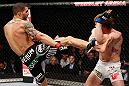 LONDON, ENGLAND - FEBRUARY 16:  (L-R) Che Mills kicks Matthew Riddle in their welterweight fight during the UFC on Fuel TV event on February 16, 2013 at Wembley Arena in London, England.  (Photo by Josh Hedges/Zuffa LLC/Zuffa LLC via Getty Images)