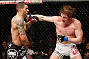 LONDON, ENGLAND - FEBRUARY 16:  (R-L) Matthew Riddle punches Che Mills in their welterweight fight during the UFC on Fuel TV event on February 16, 2013 at Wembley Arena in London, England.  (Photo by Josh Hedges/Zuffa LLC/Zuffa LLC via Getty Images)