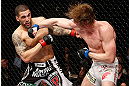 LONDON, ENGLAND - FEBRUARY 16:  (R-L) Matthew Riddle punches Che Mills in their welterweight fight during the UFC on Fuel TV event on February 16, 2013 at Wembley Arena in London, England.  (Photo by Josh Hedges/Zuffa LLC/Zuffa LLC via Getty Images)