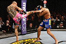 LONDON, ENGLAND - FEBRUARY 16:  (L-R) Cub Swanson kicks Dustin Poirier in their featherweight fight during the UFC on Fuel TV event on February 16, 2013 at Wembley Arena in London, England.  (Photo by Josh Hedges/Zuffa LLC/Zuffa LLC via Getty Images)