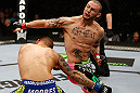 LONDON, ENGLAND - FEBRUARY 16:  (R-L) Cub Swanson throws a spinning back fist against Dustin Poirier in their featherweight fight during the UFC on Fuel TV event on February 16, 2013 at Wembley Arena in London, England.  (Photo by Josh Hedges/Zuffa LLC/Zuffa LLC via Getty Images)