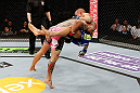 LONDON, ENGLAND - FEBRUARY 16:  (L-R) Cub Swanson takes down Dustin Poirier in their featherweight fight during the UFC on Fuel TV event on February 16, 2013 at Wembley Arena in London, England.  (Photo by Josh Hedges/Zuffa LLC/Zuffa LLC via Getty Images)