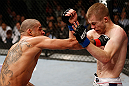 LONDON, ENGLAND - FEBRUARY 16:  (L-R) Renan Barao punches Michael McDonald in their interim bantamweight title fight during the UFC on Fuel TV event on February 16, 2013 at Wembley Arena in London, England.  (Photo by Josh Hedges/Zuffa LLC/Zuffa LLC via Getty Images)