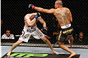 LONDON, ENGLAND - FEBRUARY 16:  (R-L) Renan Barao punches Michael McDonald in their interim bantamweight title fight during the UFC on Fuel TV event on February 16, 2013 at Wembley Arena in London, England.  (Photo by Josh Hedges/Zuffa LLC/Zuffa LLC via Getty Images)