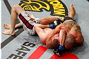 LONDON, ENGLAND - FEBRUARY 16:  (R-L) Renan Barao secures an arm triangle choke submission to defeat Michael McDonald in their interim bantamweight title fight during the UFC on Fuel TV event on February 16, 2013 at Wembley Arena in London, England.  (Photo by Josh Hedges/Zuffa LLC/Zuffa LLC via Getty Images)