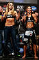 ANAHEIM, CA - FEBRUARY 22:  (L-R) Opponents Ronda Rousey and Liz Carmouche pose for photos during the UFC 157 weigh-in at Honda Center on February 22, 2013 in Anaheim, California.  (Photo by Josh Hedges/Zuffa LLC/Zuffa LLC via Getty Images)