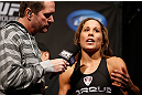 ANAHEIM, CA - FEBRUARY 22:  (R-L) Liz Carmouche is interviewed by Mike Goldberg during the UFC 157 weigh-in at Honda Center on February 22, 2013 in Anaheim, California.  (Photo by Josh Hedges/Zuffa LLC/Zuffa LLC via Getty Images)