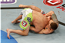 ANAHEIM, CA - FEBRUARY 23:  Brock Jardine (right) attempts to submit Kenny Robertson in their welterweight bout during UFC 157 at Honda Center on February 23, 2013 in Anaheim, California.  (Photo by Josh Hedges/Zuffa LLC/Zuffa LLC via Getty Images) *** Local Caption *** Kenny Robertson; Brock Jardine