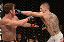 ANAHEIM, CA - FEBRUARY 23:  (R-L) Caros Fodor punches Sam Stout in their lightweight bout during UFC 157 at Honda Center on February 23, 2013 in Anaheim, California.  (Photo by Donald Miralle/Zuffa LLC/Zuffa LLC via Getty Images) *** Local Caption *** Sam Stout; Caros Fodor