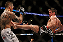ANAHEIM, CA - FEBRUARY 23:  (R-L) Sam Stout kicks Caros Fodor in their lightweight bout during UFC 157 at Honda Center on February 23, 2013 in Anaheim, California.  (Photo by Josh Hedges/Zuffa LLC/Zuffa LLC via Getty Images) *** Local Caption *** Sam Stout; Caros Fodor