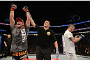 ANAHEIM, CA - FEBRUARY 23:  Sam Stout reacts to his victoy over Caros Fodor (right) in their lightweight bout during UFC 157 at Honda Center on February 23, 2013 in Anaheim, California.  (Photo by Donald Miralle/Zuffa LLC/Zuffa LLC via Getty Images) *** Local Caption *** Sam Stout; Caros Fodor