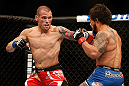 ANAHEIM, CA - FEBRUARY 23:  (L-R) Matt Grice punches Dennis Bermudez in their featherweight bout during UFC 157 at Honda Center on February 23, 2013 in Anaheim, California.  (Photo by Josh Hedges/Zuffa LLC/Zuffa LLC via Getty Images) *** Local Caption *** Dennis Bermudez; Matt Grice