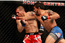 ANAHEIM, CA - FEBRUARY 23:  (R-L) Dennis Bermudez (right) punches Matt Grice in their featherweight bout during UFC 157 at Honda Center on February 23, 2013 in Anaheim, California.  (Photo by Josh Hedges/Zuffa LLC/Zuffa LLC via Getty Images) *** Local Caption *** Dennis Bermudez; Matt Grice