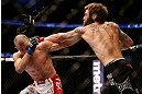 ANAHEIM, CA - FEBRUARY 23:  (R-L) Michael Chiesa punches Anton Kuivanen in their lightweight bout during UFC 157 at Honda Center on February 23, 2013 in Anaheim, California.  (Photo by Josh Hedges/Zuffa LLC/Zuffa LLC via Getty Images) *** Local Caption *** Michael Chiesa; Anton Kuivanen