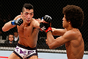 SAITAMA, JAPAN - MARCH 03:  (L-R) Kyung Ho Kang punches Alex Caceres in their bantamweight fight during the UFC on FUEL TV event at Saitama Super Arena on March 3, 2013 in Saitama, Japan.  (Photo by Josh Hedges/Zuffa LLC/Zuffa LLC via Getty Images)
