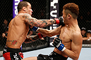SAITAMA, JAPAN - MARCH 03:  (L-R) Cristiano Marcello punches Kazuki Tokudome in their lightweight fight during the UFC on FUEL TV event at Saitama Super Arena on March 3, 2013 in Saitama, Japan.  (Photo by Josh Hedges/Zuffa LLC/Zuffa LLC via Getty Images)