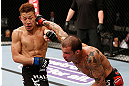 SAITAMA, JAPAN - MARCH 03:  (R-L) Cristiano Marcello punches Kazuki Tokudome in their lightweight fight during the UFC on FUEL TV event at Saitama Super Arena on March 3, 2013 in Saitama, Japan.  (Photo by Josh Hedges/Zuffa LLC/Zuffa LLC via Getty Images)