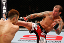 SAITAMA, JAPAN - MARCH 03:  (R-L) Cristiano Marcello kicks Kazuki Tokudome in their lightweight fight during the UFC on FUEL TV event at Saitama Super Arena on March 3, 2013 in Saitama, Japan.  (Photo by Josh Hedges/Zuffa LLC/Zuffa LLC via Getty Images)