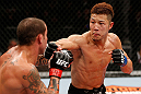 SAITAMA, JAPAN - MARCH 03:  (R-L) Kazuki Tokudome punches Cristiano Marcello in their lightweight fight during the UFC on FUEL TV event at Saitama Super Arena on March 3, 2013 in Saitama, Japan.  (Photo by Josh Hedges/Zuffa LLC/Zuffa LLC via Getty Images)