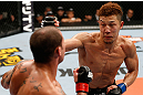 SAITAMA, JAPAN - MARCH 03:  (R-L) Kazuki Tokudome punches Cristiano Marcello in their lightweight fight during the UFC on FUEL TV event at Saitama Super Arena on March 3, 2013 in Saitama, Japan.  (Photo by Josh Hedges/Zuffa LLC/Zuffa LLC via Getty Images)