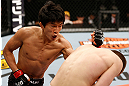 SAITAMA, JAPAN - MARCH 03:  (L-R) Takeya Mizugaki punches Bryan Caraway in their bantamweight fight during the UFC on FUEL TV event at Saitama Super Arena on March 3, 2013 in Saitama, Japan.  (Photo by Josh Hedges/Zuffa LLC/Zuffa LLC via Getty Images)