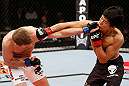 SAITAMA, JAPAN - MARCH 03:  (R-L) Takeya Mizugaki and Bryan Caraway trade punches in their bantamweight fight during the UFC on FUEL TV event at Saitama Super Arena on March 3, 2013 in Saitama, Japan.  (Photo by Josh Hedges/Zuffa LLC/Zuffa LLC via Getty Images)