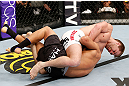 SAITAMA, JAPAN - MARCH 03:  Bryan Caraway (top) attempts to submit Takeya Mizugaki with a guillotine choke in their bantamweight fight during the UFC on FUEL TV event at Saitama Super Arena on March 3, 2013 in Saitama, Japan.  (Photo by Josh Hedges/Zuffa LLC/Zuffa LLC via Getty Images)