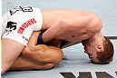 SAITAMA, JAPAN - MARCH 03:  Bryan Caraway (top) attempts to submit Takeya Mizugaki with a guillotine choke in their bantamweight fight during the UFC on FUEL TV event at Saitama Super Arena on March 3, 2013 in Saitama, Japan.  (Photo by Josh Hedges/Zuffa LLC/Zuffa LLC via Getty Images)